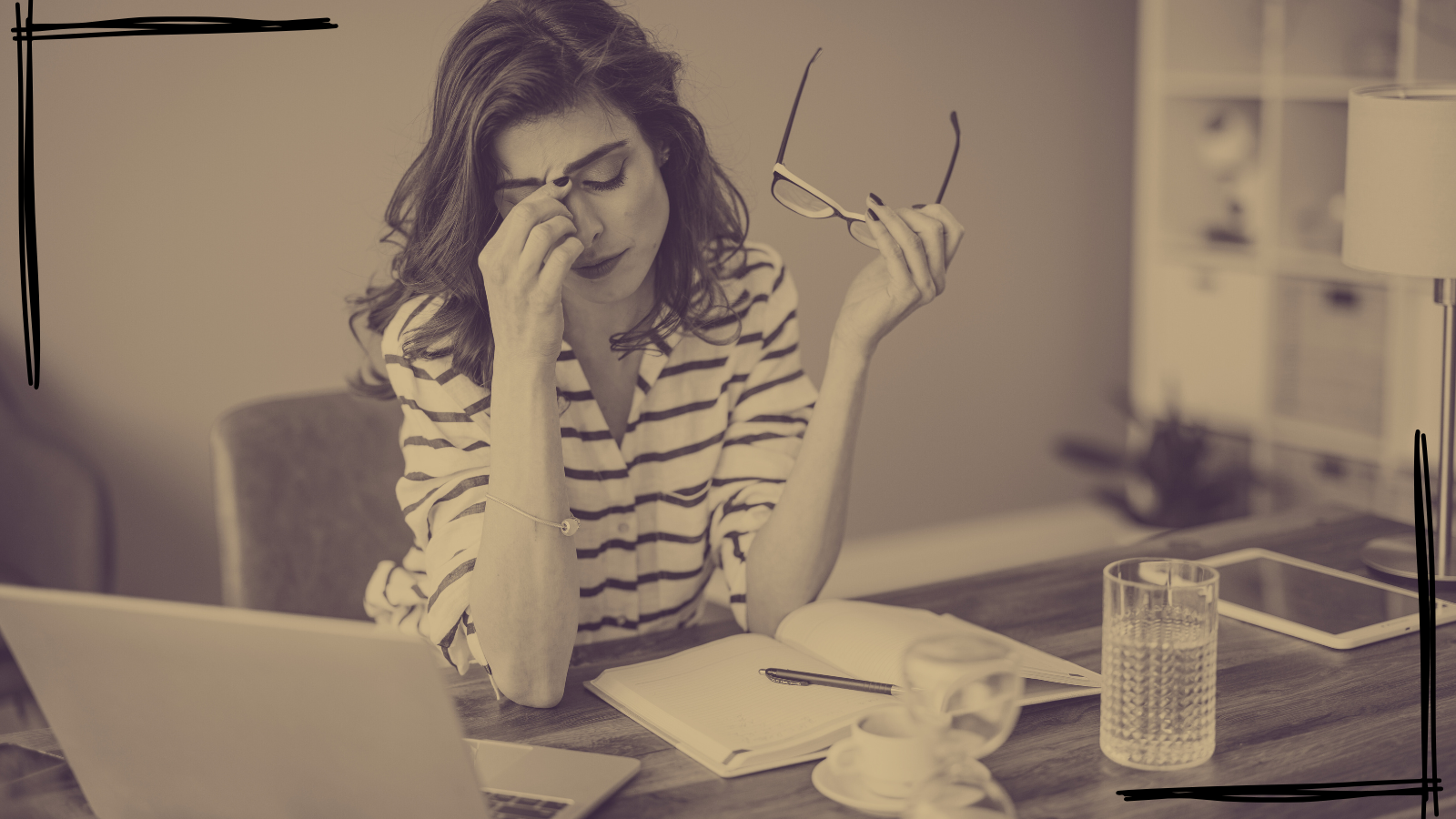 Stressed woman at work looking overwhelmed at her desk—symbolizing burnout and imbalance